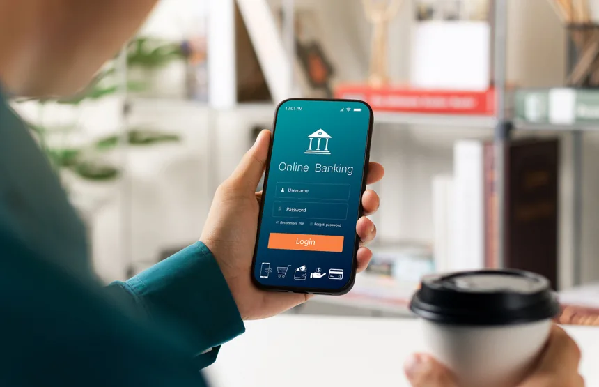 Male executive using smartphone to conduct online mobile banking