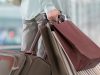 Mature woman waiting at airport with shopping bags