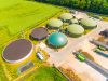 Aerial view over biogas plant and farm in green fields. Renewable Energy Association
