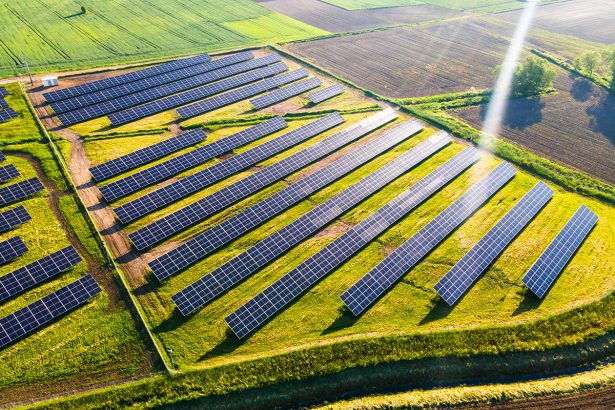 Solar Energy Farm in Fields. Aerial Drone View